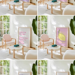 May include: A light-filled room with a modern aesthetic, featuring a pink armchair, a small white table, and framed art prints. The prints display playful text and illustrations, including a lemon, cocktail glasses, and floral designs. A teal box sits on the table.