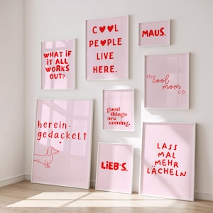 May include: A collection of framed art prints with pink backgrounds and red text. The prints feature various phrases like "Cool People Live Here," "What If It All Works Out?" and "Good Things Are Coming." A dachshund illustration is also present.