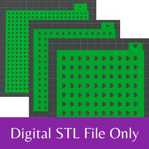 May include: Three green stencils with a heart pattern. The stencils are layered on top of each other, with the largest stencil in the back and the smallest stencil in the front. The stencils are on a gray background.