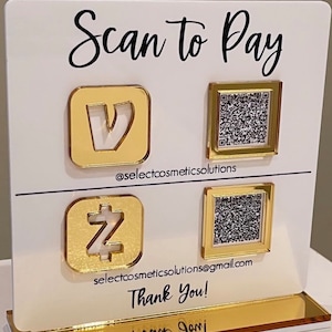 May include: White sign with gold accents and the text "Scan to Pay".  There are two QR codes and two logos, one for Venmo and one for Zelle. The text "@selectcosmeticsolutions" and "selectcosmeticsolutions@gmail.com" are also included. The sign says "Thank You!" at the bottom.