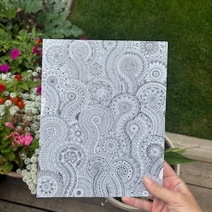 May include: A rectangular print featuring a dense, intricate black and white pattern composed of numerous interconnected circular mandala designs and swirling paisley-like shapes, creating a complex, repetitive, and highly detailed graphic illustration.