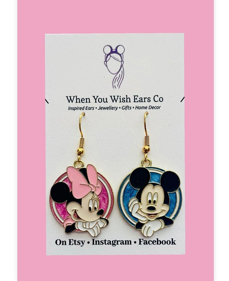 May include: Gold-tone dangle earrings featuring a cartoon image of Mickey Mouse and Minnie Mouse. The earrings are on a white card with the text "When You Wish Ears Co" and "Inspired Ears - Jewellery - Gifts - Home Decor".