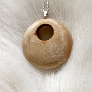 Pendant handcrafted from reindeer antler and wood.