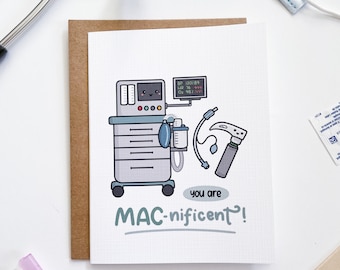 May include: A white card with a cartoon illustration of a medical machine with a smiling face. The card says "You are MAC-nificent!"
