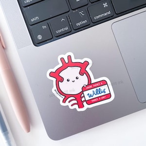 May include: A white sticker with a cartoon-style red circle with a smiling face and red lines. The sticker includes a name tag that says "Willis" and "Where there's a way!"