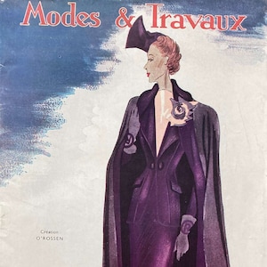 May include: A vintage fashion illustration from Modes & Travaux magazine, October 15, 1937, featuring a woman wearing a purple suit with a long cape and a hat. The illustration is in a retro style with a soft, muted color palette.
