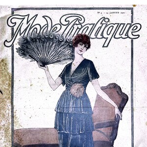 May include: A vintage magazine cover featuring a woman in a blue dress holding a peacock feather fan. The magazine is titled "Mode Pratique" and the cover text reads "Les Petites Robes - Jour-Soir" and "Lire Partide dans ce numero".