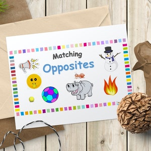 May include: A white card with the words "Matching Opposites" in blue and colourful squares around the border. The card has images of a megaphone, a sun, a football, a hippopotamus, a flame, and a snowman.