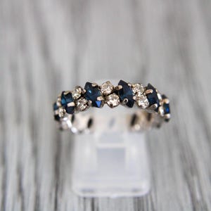 Op de afbeelding: Een set van drie keramische nestkommen in blauwe, groene en witte tinten. De kommen hebben een gespikkelde glazuur en een eenvoudig, modern ontwerp. De grootste kom heeft een diameter van ongeveer 15 cm.