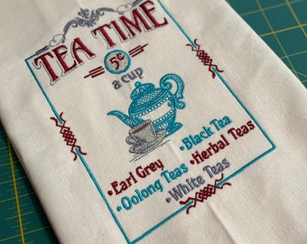 May include: White tea towel with embroidered text "TEA TIME 5¢ a cup" and a teapot with a cup and saucer. The text also lists different types of tea: Earl Grey, Black Tea, Oolong Teas, Herbal Teas, and White Teas.