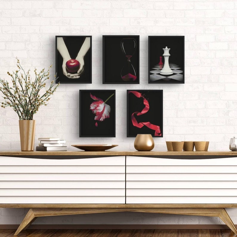 May include: Five black framed prints with different images. The images include a red apple, an hourglass, a white chess piece, a red ribbon, and a white tulip.