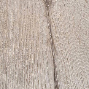 May include: Close-up of a light brown wood grain surface with a darker brown line running vertically down the center.
