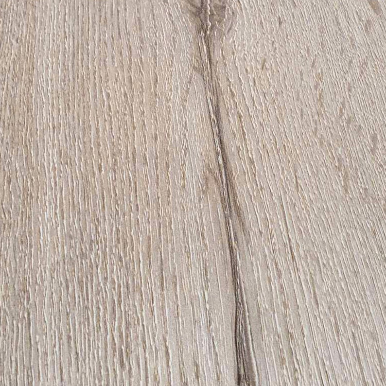 May include: Close-up of a light brown wood grain surface with a darker brown line running vertically down the center.