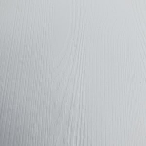 May include: A close-up of a white painted wood surface with a wood grain pattern.