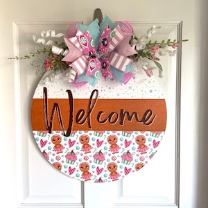 Winter gingerbread and candy inspired welcome door hanger in pastel colors