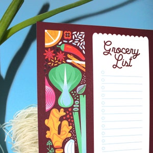 May include: A brown grocery list notepad with a white border and a white background. The notepad has a colorful illustration of various vegetables and spices on the left side. The text "Grocery List" is printed in a brown font at the top of the notepad.