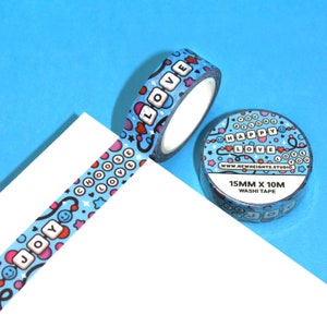 May include: A roll of blue washi tape with a colorful pattern of hearts, stars, smiley faces, and the words "Choose Love", "Joy", and "Happy Love". The tape is 15mm wide and 10m long.