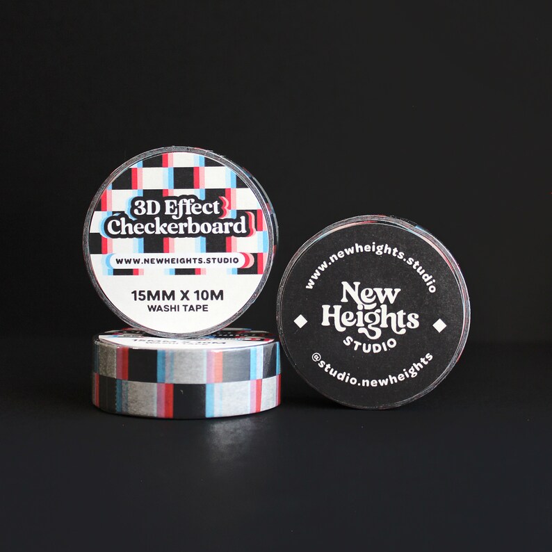 May include: Three rolls of washi tape with a black and white checkered pattern. The tape is labeled "3D Effect Checkerboard" and "15MM x 10M Washi Tape". The tape is also labeled with the website "www.newheights.studio".