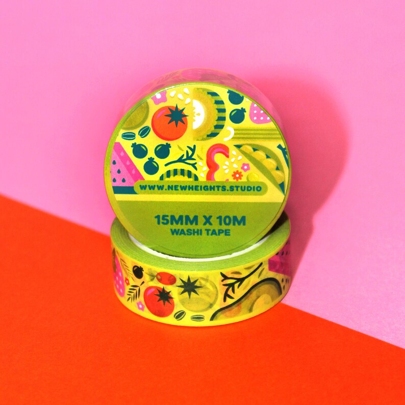 May include: Two rolls of yellow washi tape with a colorful fruit and vegetable design. The tape is 15mm wide and 10m long. The text on the tape reads "www.newheights.studio" and "15mm x 10m washi tape".
