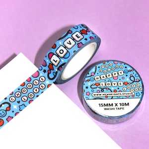 May include: Blue and pink washi tape with a repeating pattern of hearts, stars, smiley faces, and the words "Choose Love", "Happy", and "Love". The tape is 15mm wide and 10m long.