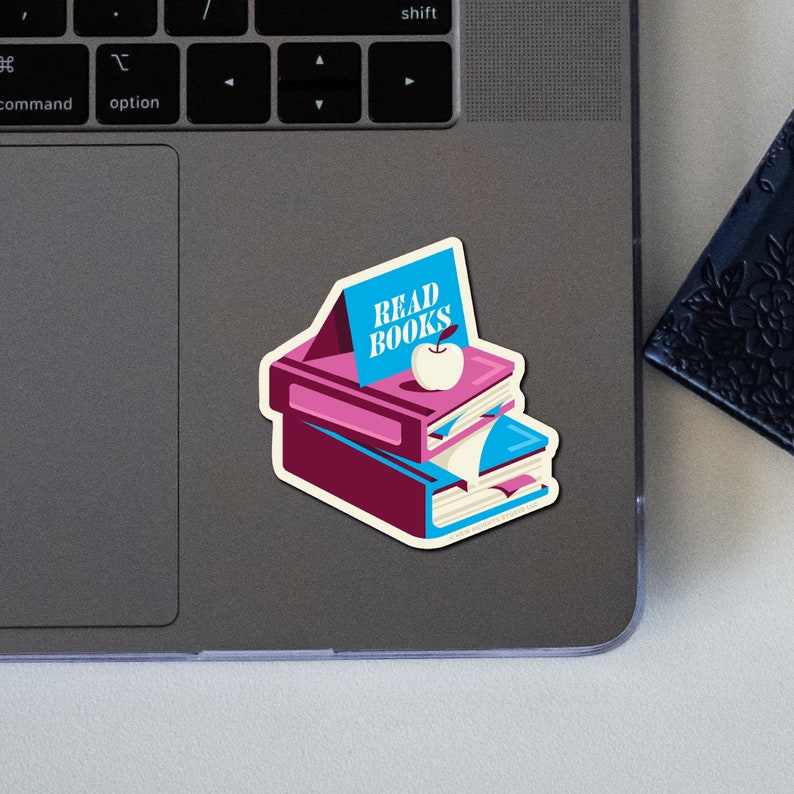 May include: A sticker of a stack of books with a blue sign that says "READ BOOKS" and a red apple on top.