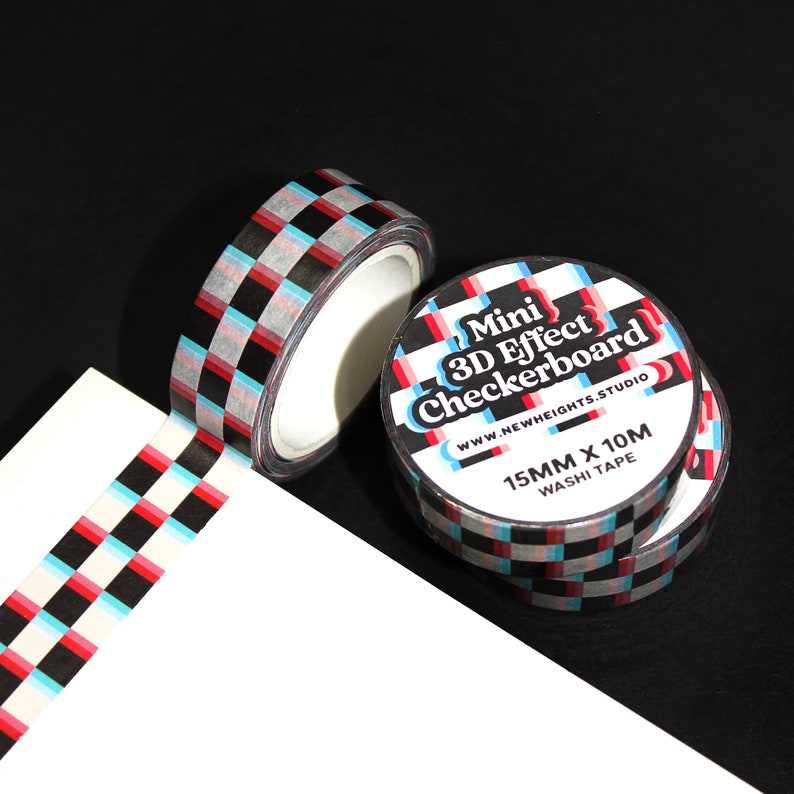 May include: A roll of black and white checkered washi tape with red and blue accents. The tape is labeled "Mini 3D Effect Checkerboard" and "15mm x 10m Washi Tape".