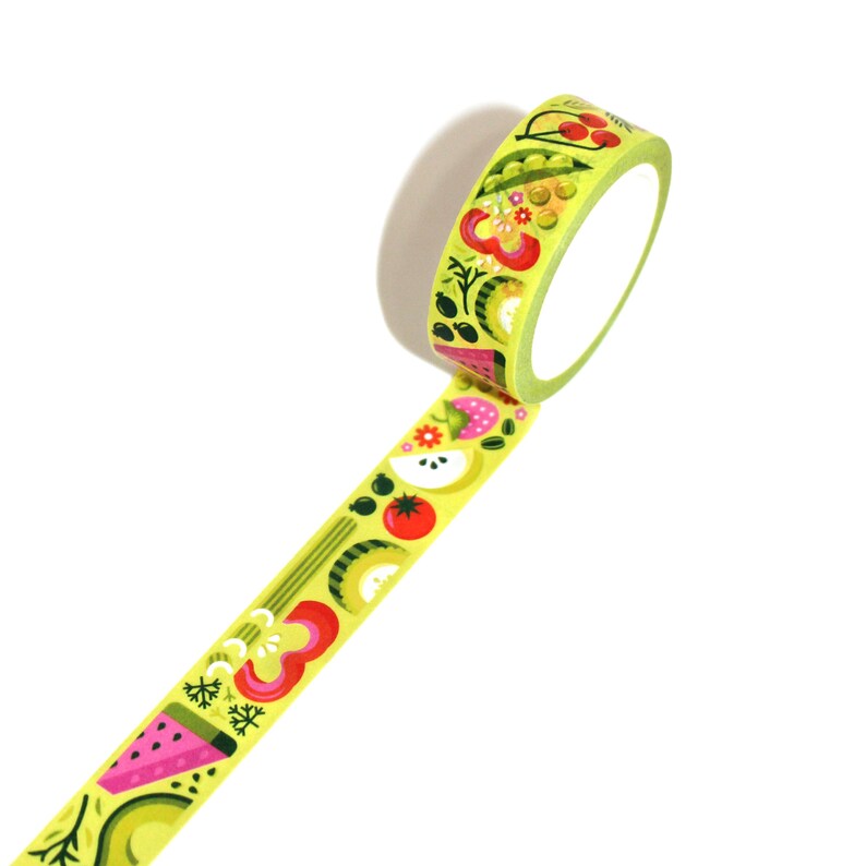 May include: A roll of yellow washi tape with a colorful fruit and vegetable design. The tape features illustrations of watermelon, avocado, apples, tomatoes, and peas.