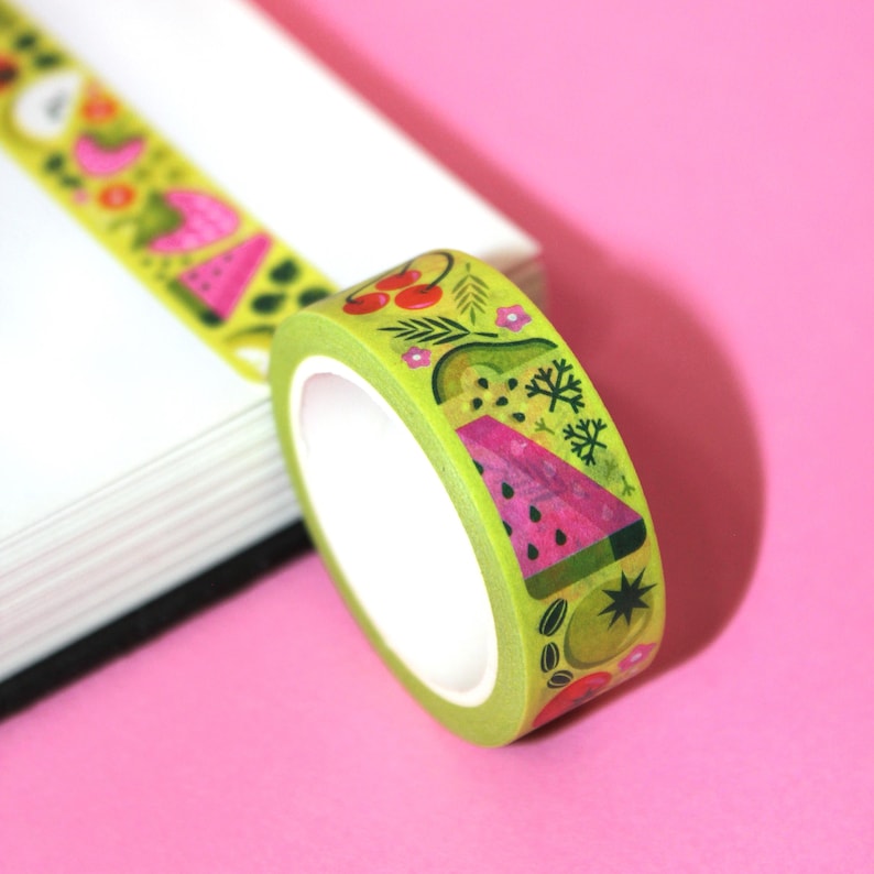 May include: A roll of green washi tape with a colorful fruit pattern. The tape features watermelon, cherries, avocado, and other fruits.