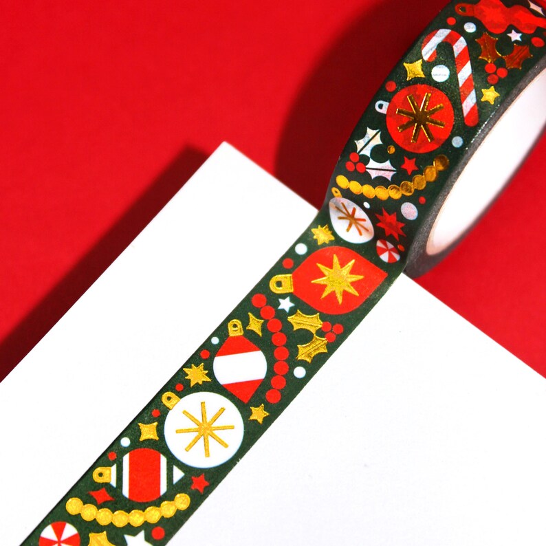 A close-up view of the washi tapes to show the pattern’s details featuring unique styled ornaments, garlands, candy canes, and mistletoes.