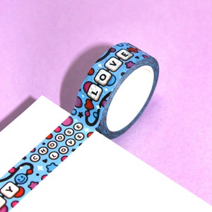 May include: A roll of blue washi tape with a repeating pattern of hearts, stars, and the words "Choose Love" and "Love".