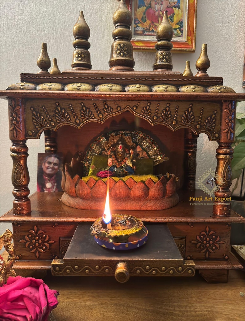 Handcrafted Wooden Mandir for Home featuring premium solid wood craftsmanship, traditional carved pillars, elegant brass detailing and spacious prayer area beautifully decorated with a divine Goddess Lakshmi idol and glowing diya. Perfect for daily pooja, meditation, festive celebrations and spiritual home décor. #WoodenMandir #PoojaMandir #HomeTemple #TempleDecor #IndianHomeDecor #HandmadeFurniture #WoodenTemple #LuxuryHomeDecor #SpiritualDecor #EtsyFinds