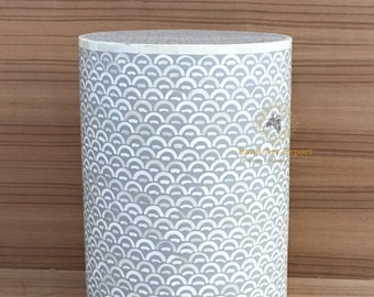 May include: A round, gray and white side table with a decorative pattern of white circles on a gray background. The table is made of mother of pearl.