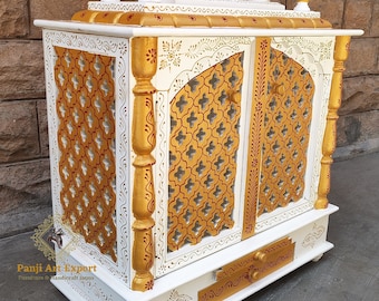 May include: White wooden temple with gold accents and intricate carvings. The temple has two doors with a lattice design and a drawer at the bottom. The temple is decorated with red and gold paint.