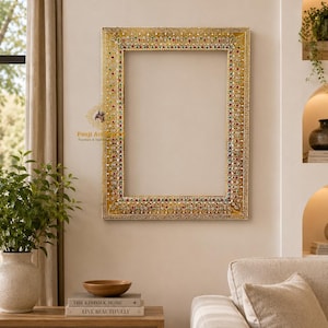 May include: A rectangular wall mirror frame featuring an intricate gold finish with embedded red, green, and clear decorative stones. The frame displays a repeating pattern of teardrop and floral motifs throughout its border, with the text Panji Art.