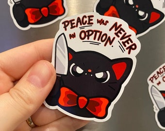 May include: A black cat with red ears and a red bow tie holds a knife and says "Peace was never an option."