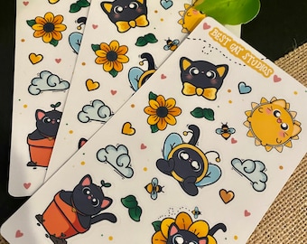 May include: Three sheets of stickers featuring black cats with different designs. The stickers include a black cat wearing a bow tie, a black cat in a sunflower, a black cat in a bee costume, a black cat in a pot, a sun, clouds, and bees. The text on the stickers reads "Best Cat Studios" and "www.bestcatstudios.com".
