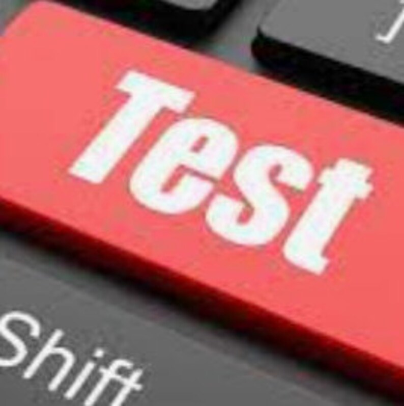 Puede incluir: Una tecla de computadora roja con la palabra "Test" en letras blancas.