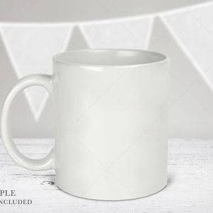 May include: A plain white ceramic mug with a smooth, glossy finish and a curved handle on the left side. The mug features a cylindrical body with a wide opening at the top and a flat base, designed for holding hot or cold beverages in a simple style.