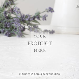 May include: A white textured surface with a sprig of lavender and a white vase. Text in the image reads "YOUR PRODUCT HERE" and "INCLUDES 3 BONUS BACKGROUNDS". The Background Company logo is in the upper right corner.