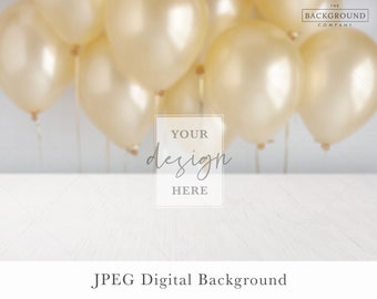 May include: A digital background featuring a white wooden surface in the foreground and a cluster of out-of-focus metallic gold balloons in the background. A central rectangular frame contains the text YOUR design HERE, with THE BACKGROUND COMPANY in the top right corner and JPEG Digital Background at the bottom.