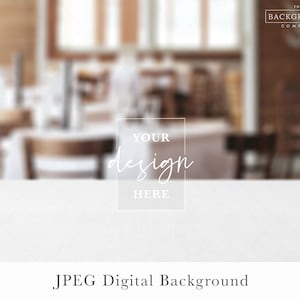 May include: A white table top with a blurred background of a restaurant interior. The text "YOUR design HERE" is in a white box on the table.