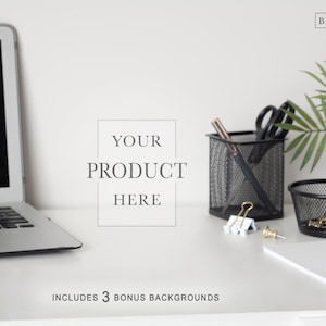 May include: A desk setup featuring a laptop, black mesh pen holders, scissors, and a small potted plant. The text "YOUR PRODUCT HERE" is displayed, along with "INCLUDES 3 BONUS BACKGROUNDS". The Background Company logo is in the top right.