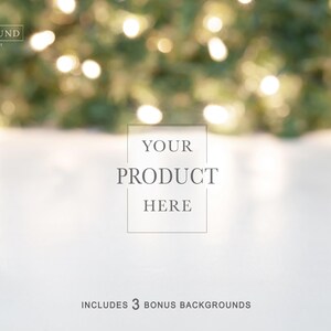 May include: A digital photography backdrop featuring a smooth white surface in the foreground and a blurred background of green pine branches with glowing warm white fairy lights. The text reads THE BACKGROUND COMPANY, YOUR PRODUCT HERE, INCLUDES 3 BONUS BACKGROUNDS.