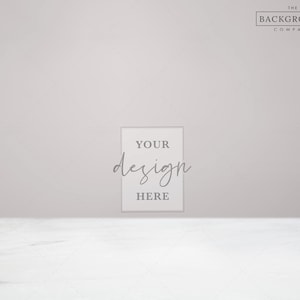 May include: A white rectangular frame with the text "YOUR design HERE" on a white marble surface against a light grey background.
