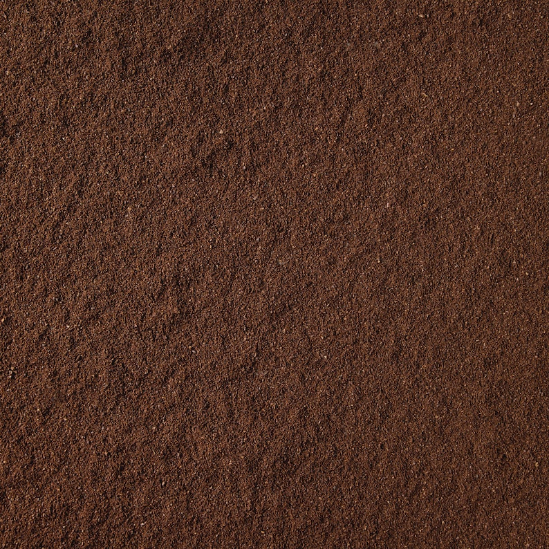 May include: Close-up of a dark brown ground VIP123. The VIP123 is finely ground and has a rich, earthy aroma.