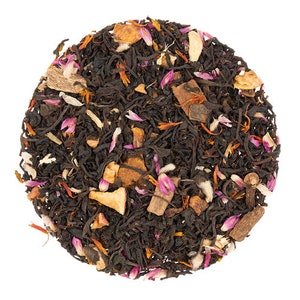 May include: A close-up of a blend of black tea leaves, dried fruit pieces, and spices, including cinnamon sticks, apple pieces, and flower petals.