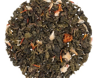 May include: A close-up of a blend of loose leaf green tea with dried orange peel and white flower petals.
