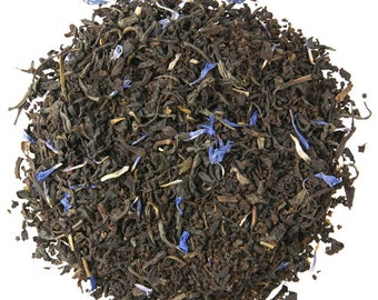 May include: A close-up of a pile of loose leaf black tea with blue cornflower petals.