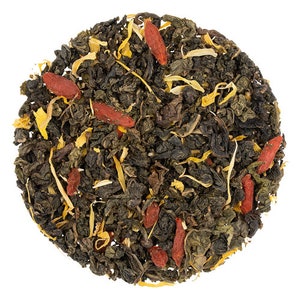 May include: A close-up of a blend of green tea, dried mango, and goji berries. The tea is a mix of loose leaf green tea, dried mango pieces, and red goji berries.