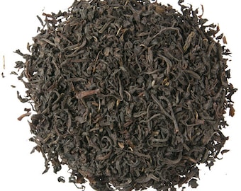 May include: Loose black tea leaves, dried and ready for brewing. The tea leaves are dark brown and have a slightly curled shape.